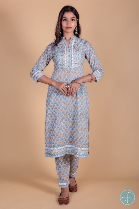 A-Line kurta dipped in light color base with floral peach and yellow block print is a perfect choice for the summer season. This 3/4th sleeves kurta set is embellished with sequins buttons  throughout the length Gota detailing can be seen on the neck,slee